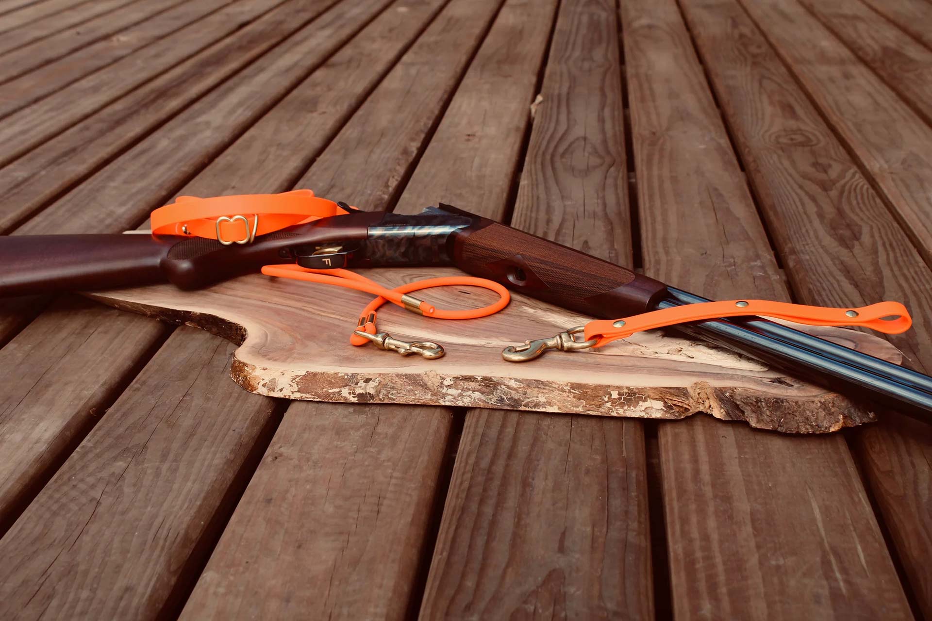 vest buddy and gun on a piece of wood